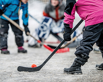 children playing ball hockey
